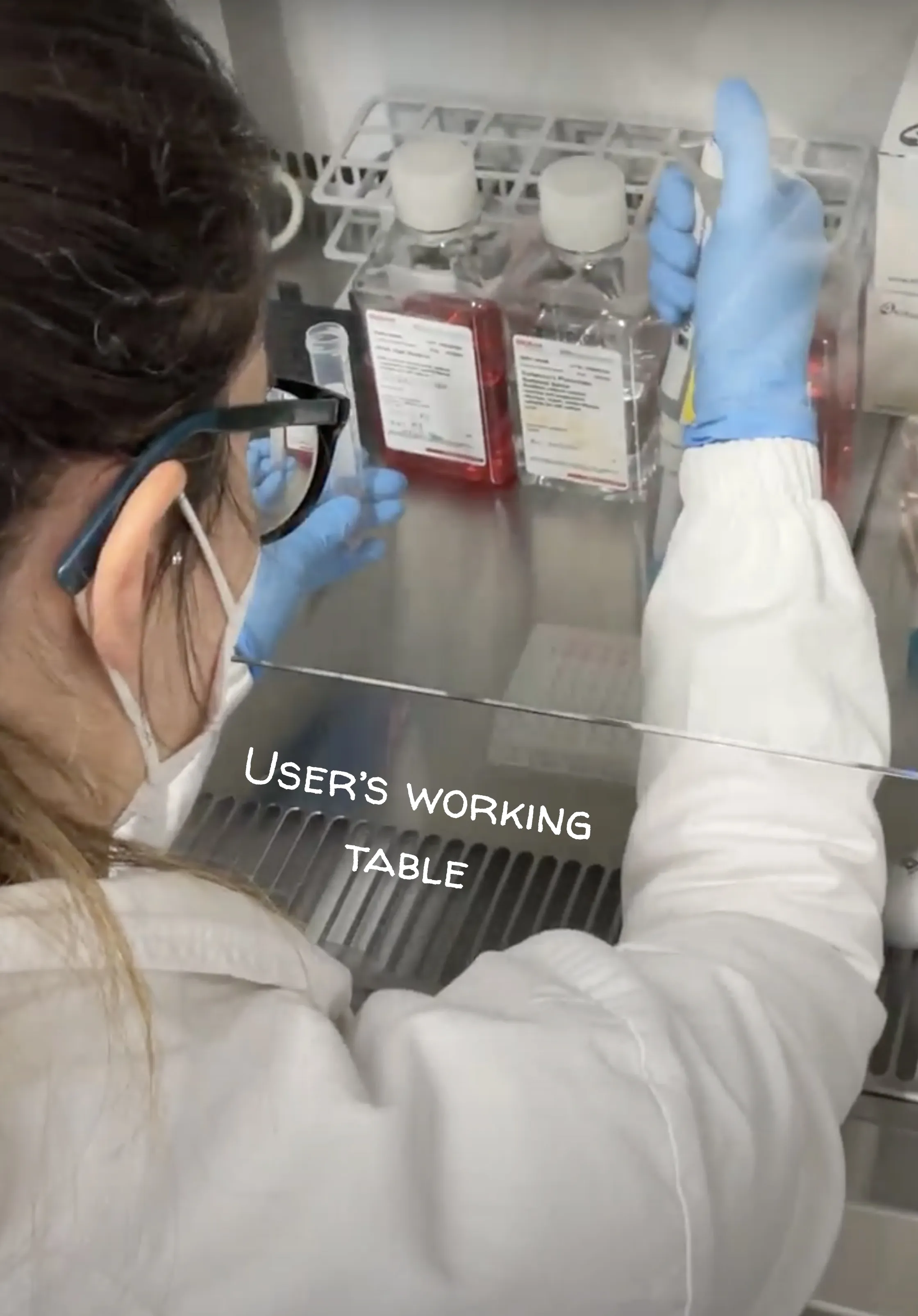 A biologist fills a plate of cells in a laboratory